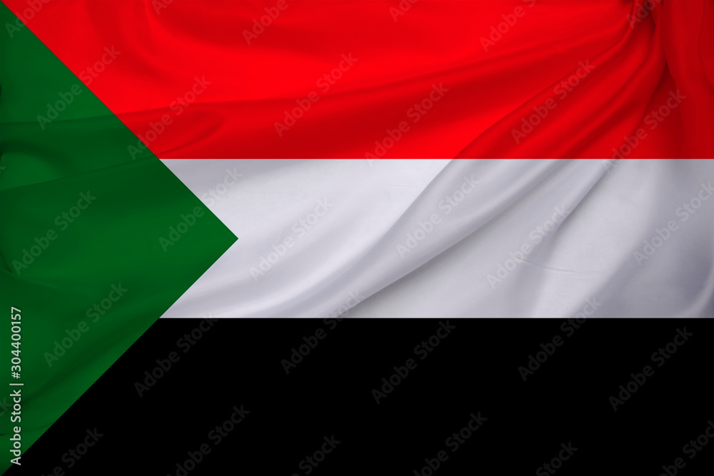 photo of the beautiful colored national flag of the modern state of Sudan on a textured fabric, concept of tourism, emigration, economics and politics, closeup