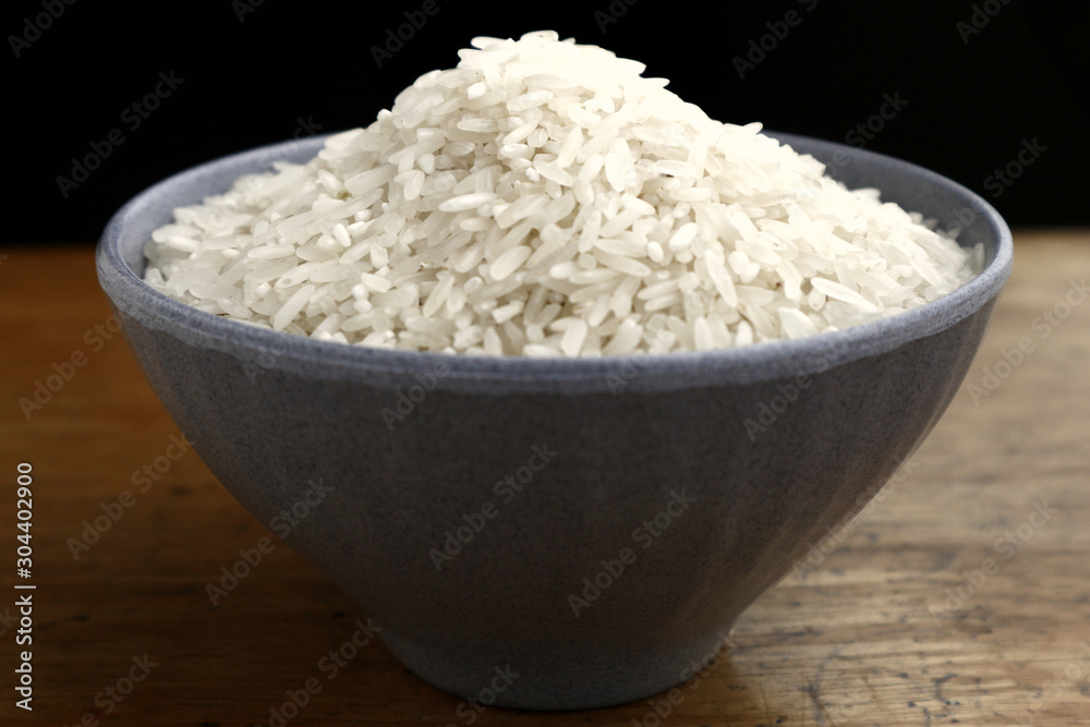 Bowl of raw rice on a table Bowl of raw rice on a table