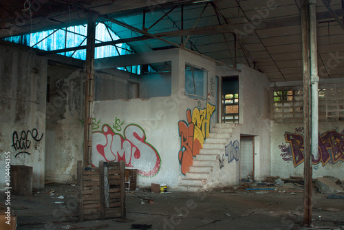 Abandoned dirty industry building with graffiti photo