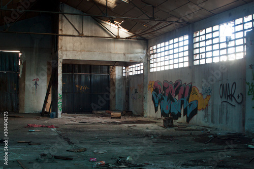 Abandoned dirty industry building with graffiti photo