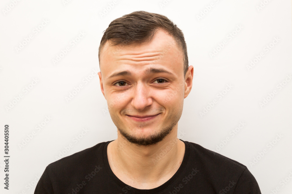 Fototapeta premium emotion smile, young man on a white background, human emoji