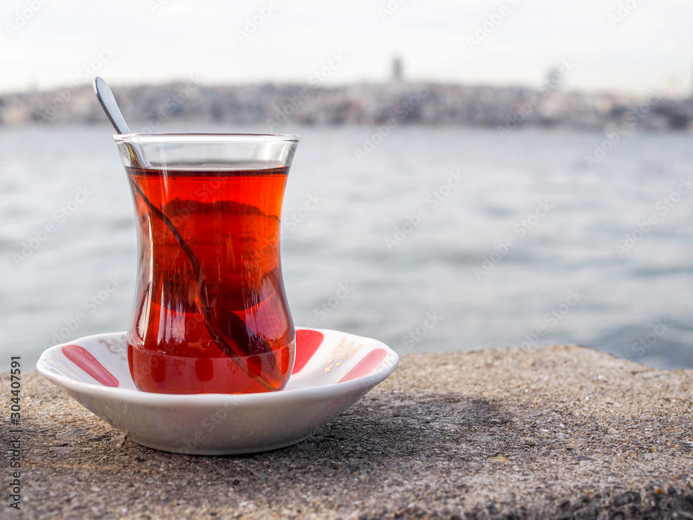 glass of Turkish tea next to sea in Turkey glass of Turkish tea next to sea in Turkey