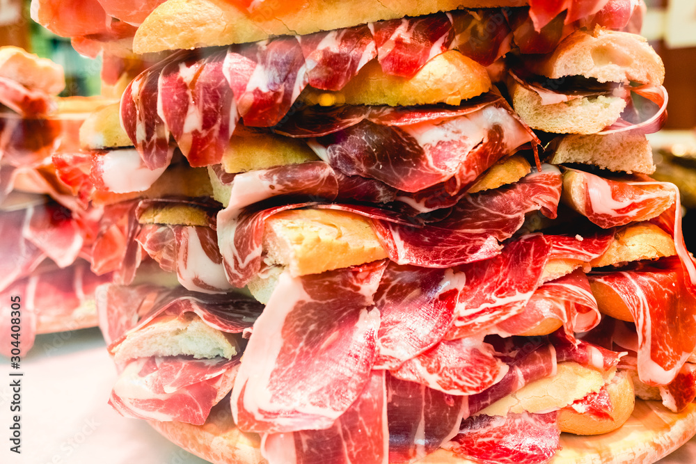 Snacks in baguette bread with serrano ham. Snacks in baguette bread with serrano ham.
