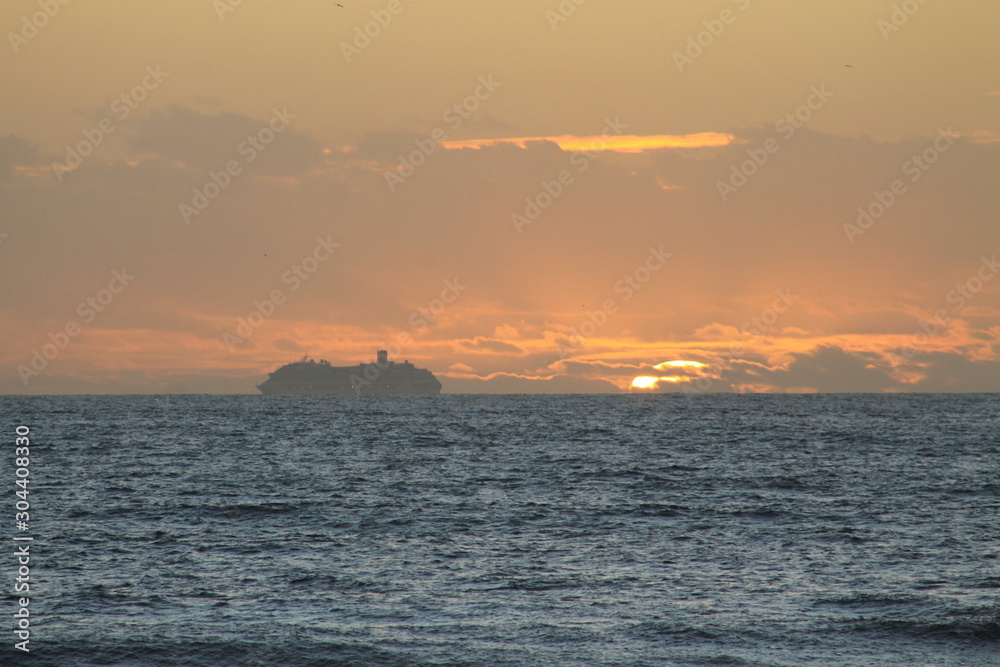 cruise ship in sunset on the horizon