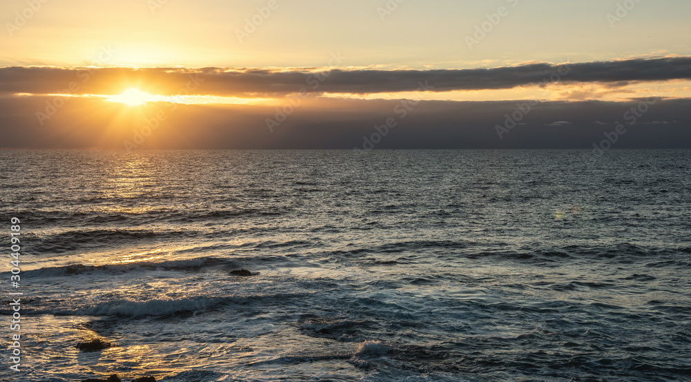 Sun shining over the sea at sunset