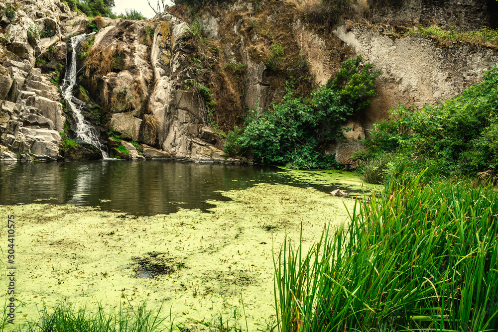 Triulintas waterfall surrounded by vegetation Triulintas waterfall surrounded by vegetation