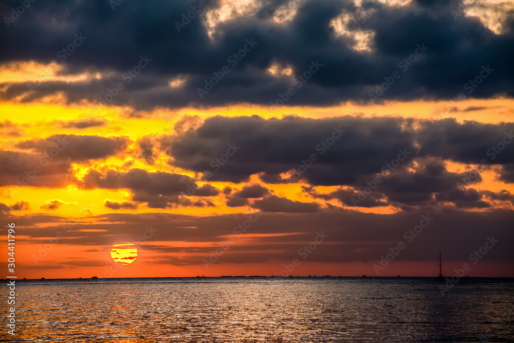 Dramatic sky over Alghero shore at sunset