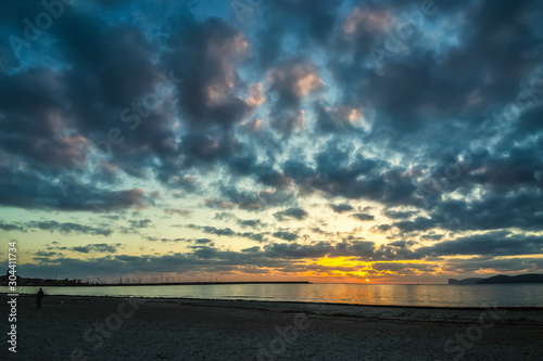 Dark clouds over Alghero coast at sunset