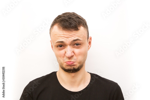 emotion slightly frowining face, young man in a black cap on a white background, man emoji