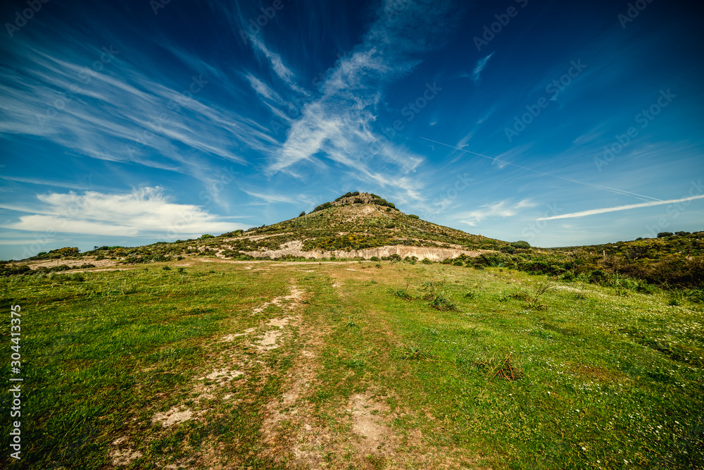 Fototapeta premium Green hill under a blue sky in Sardinia