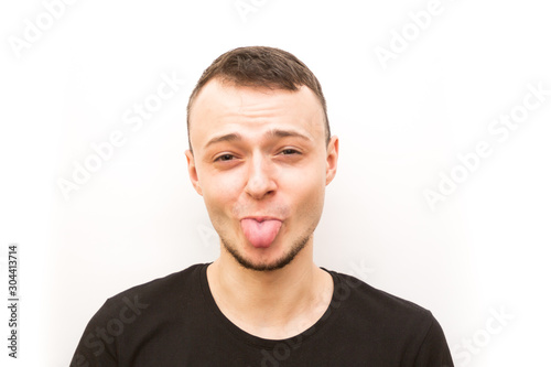 emotion stuck out tonge, young man in a black cap on a white background, man emoji