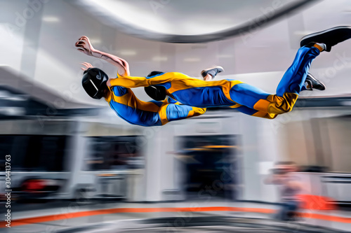 Flight. Peoples fly in wind tunnel. Indoor skydiving. Swim in wind tunnel. New sport in flight technology.