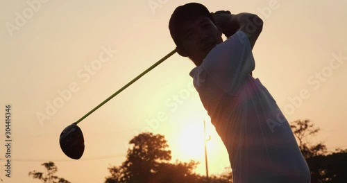 Professional golfer playing golf course with sunset background. People, sport, leisure activity, recreation and lifestyle concept. Slow motion shot.