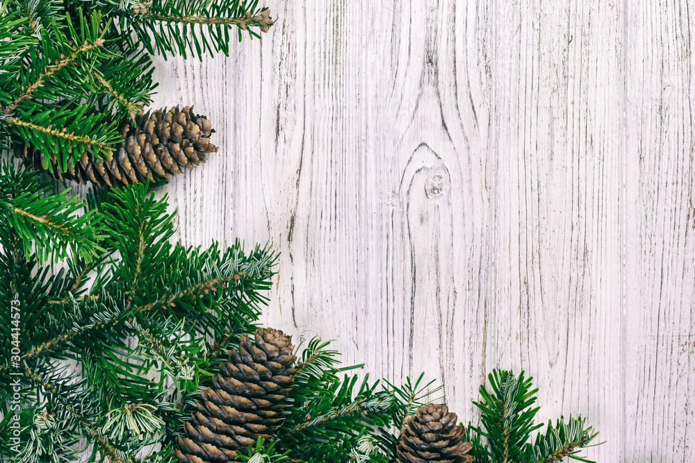 Christmas wooden background with fir tree and pine cone. Top view, copy space. Toned Christmas wooden background with fir tree and pine cone. Top view, copy space. Toned