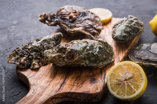 Fresh open Oysters. Healthy sea food. Dinner in restaurant. Gourmet food. Dark background. Top view Healthy sea food.