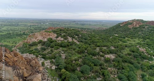 Aerial View, Green Mountain Ranges and scrubs forest -  Cinematic Dolly Zoom out shot of a Hills with green shrubs and trees. photo