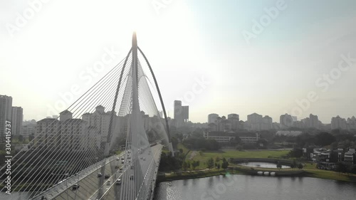 Putrajaya, Malaysia. Steady shot from a drone of cars passing over the bridge. 250ft approximately. photo