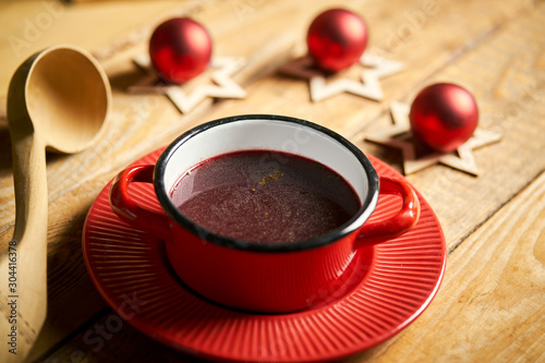 Traditional christmas borscht red in pot on old wooden table
