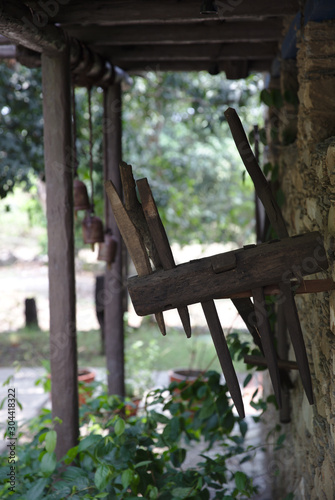 NB__7688 Wooden agricultural tools hanging on wall