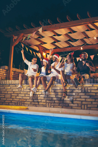 Friends at poolside New Years Eve party