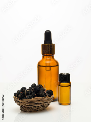 Decoction of chokeberry with dried chokeberry on white background