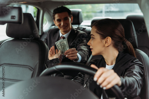 Smiling businessman paying off with taxi driver © LIGHTFIELD STUDIOS