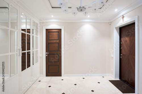 white wardrobe in the hallway with stained glass mirror doors