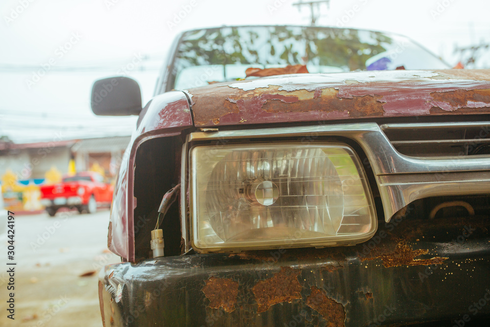 Fototapeta premium Old broken and rusty Car in summer Asia