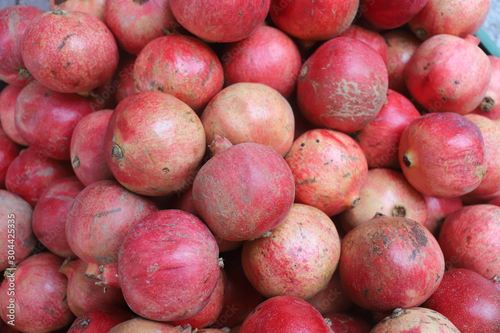 closeup of pomegranates on display at the market closeup of pomegranates on display at the market