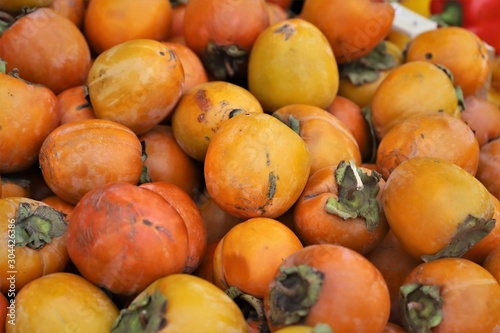 closeup of persimmons on display at the market