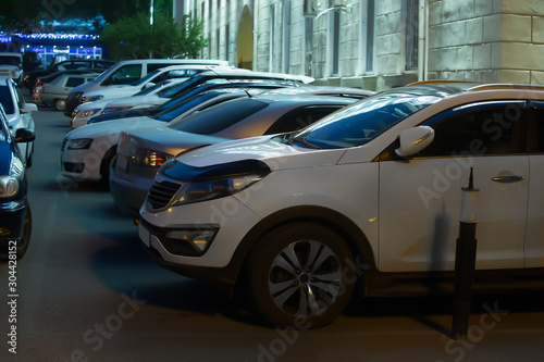Cars in the parking lot on at night © Yuri Bizgaimer