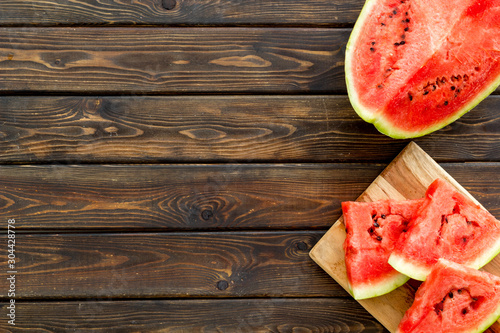 Cut watermelon for break with fruit on wooden background top view mockup