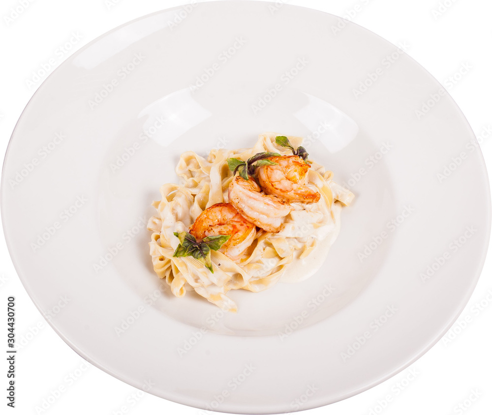 Handmade creamy pasta cooked on a shrimp biscuit, flavored with lemon pepper. Served with tiger prawns fried in aromatic herbs on white plate.