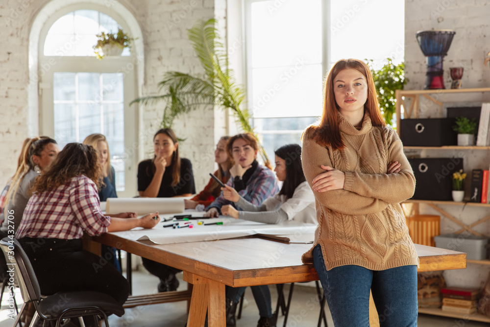 Women's rights and equality at the office. Caucasian businesswomen or young confident model crossed hands in front of coworkers having meeting about problem in workplace, male pressure and harassment. Women's rights and equality at the office. Caucasian businesswomen or young confident model crossed hands in front of coworkers having meeting about problem in workplace, male pressure and harassment.