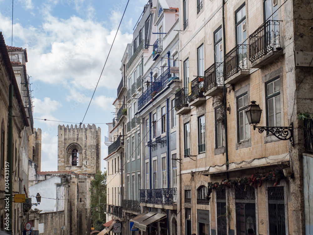 Street counts down with a bell tower in Lisbon