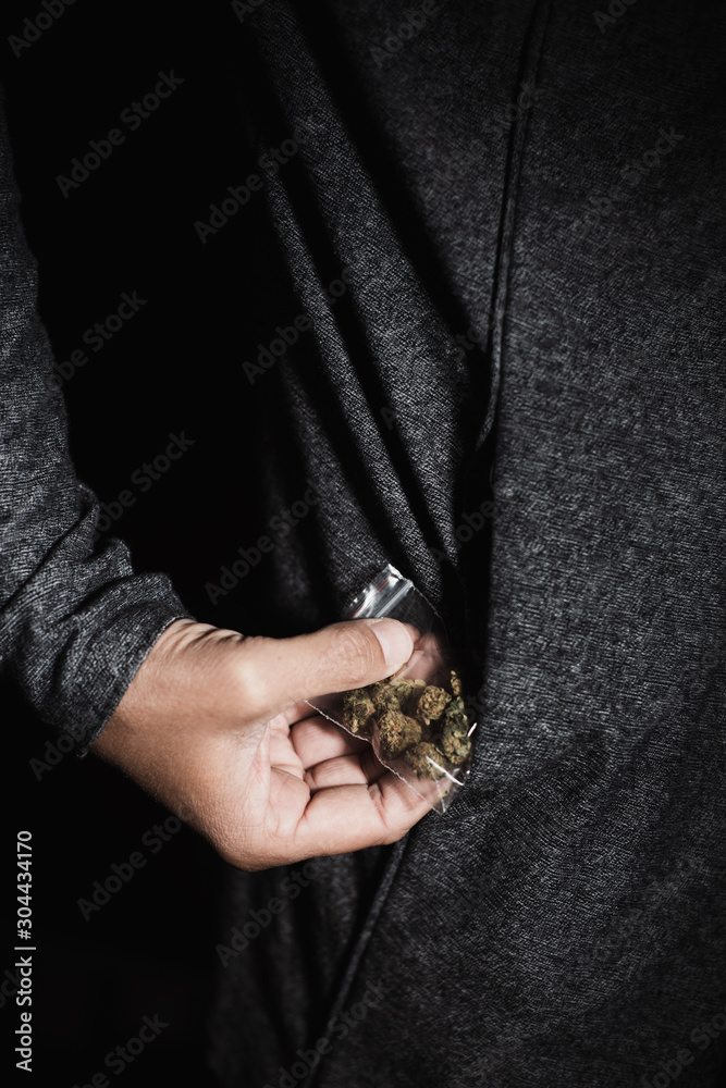 Obraz premium young man with a bag of marihuana buds