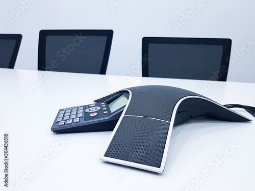 Business conference phone set up in the meeting room. Communication technology for voice conference meeting for long distance office or workplace