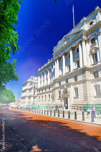 LONDON, UK - JUNE 2015: Tourists enjoy city visit near a park on a beautiful sunny day