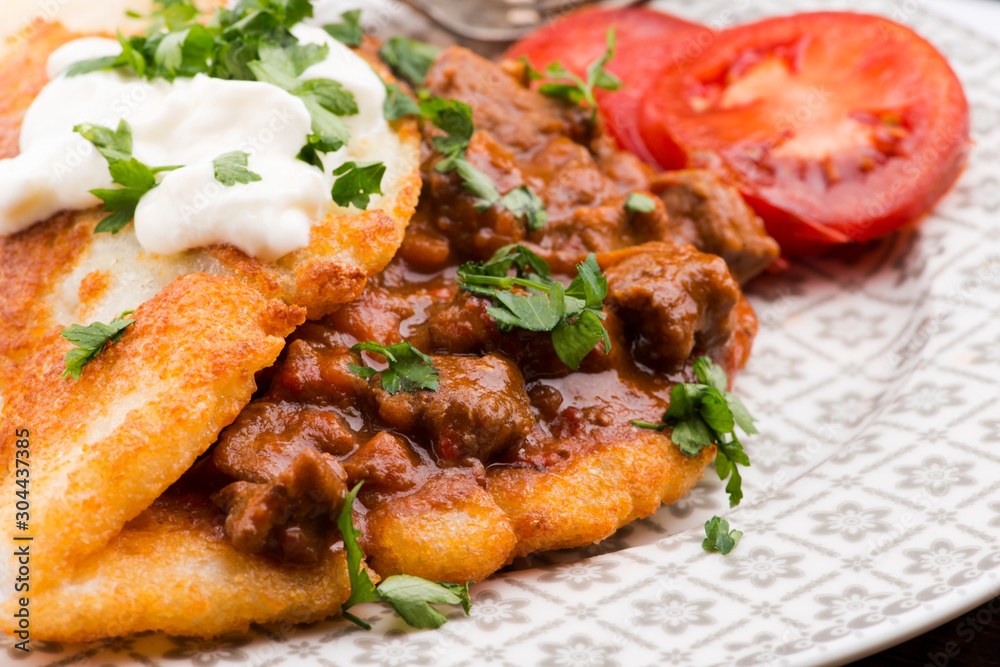Potato pancakes with meat, vegetable, tomato and parsley Potato pancakes with meat, vegetable, tomato and parsley