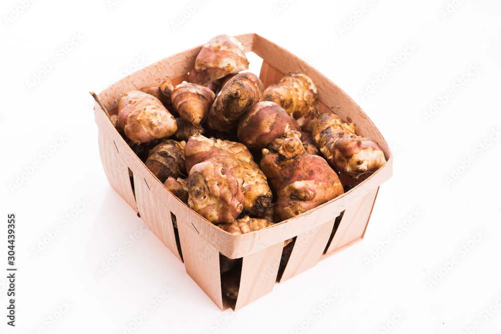Raw Whole ans sliced Jerusalem artichokes on a white background Raw Whole ans sliced Jerusalem artichokes on a white background