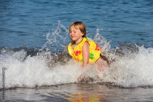 child in the waves at sea