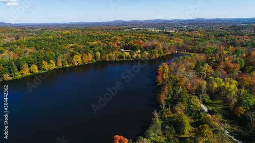 Aerial drone view of lake in autumn state park.