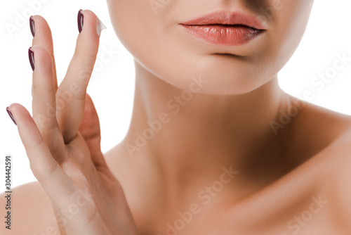 cropped view of naked woman with face cream on finger isolated on white
