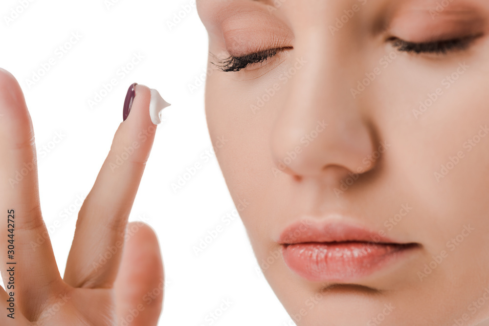 close up of woman with closed eyes and face cream on finger isolated on white close up of woman with closed eyes and face cream on finger isolated on white