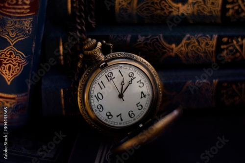 Vintage Antique pocket watch placed with old books in background
