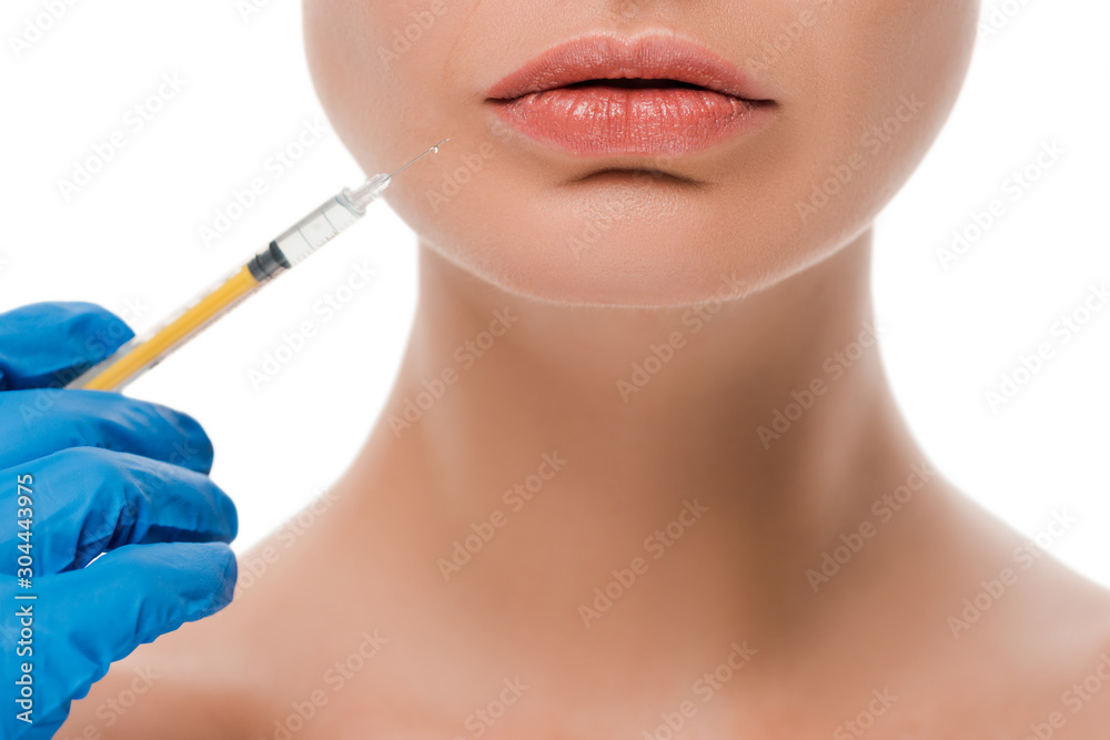 cropped view of plastic surgeon in blue latex glove holding syringe near naked patient isolated on white cropped view of plastic surgeon in blue latex glove holding syringe near naked patient isolated on white
