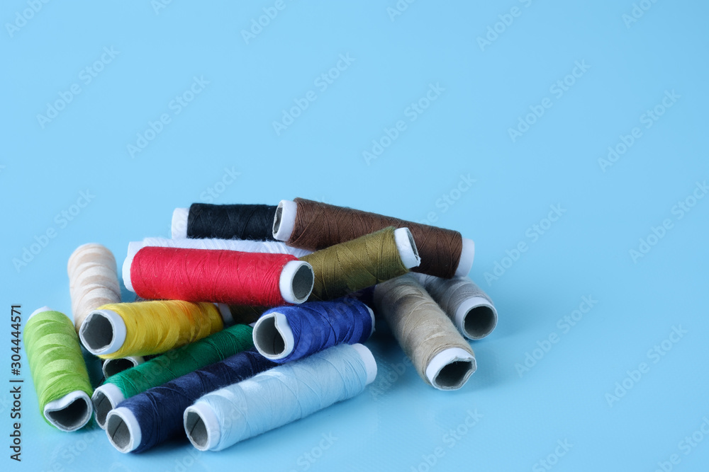Thread tube colorful on blue background Thread tube colorful on blue background