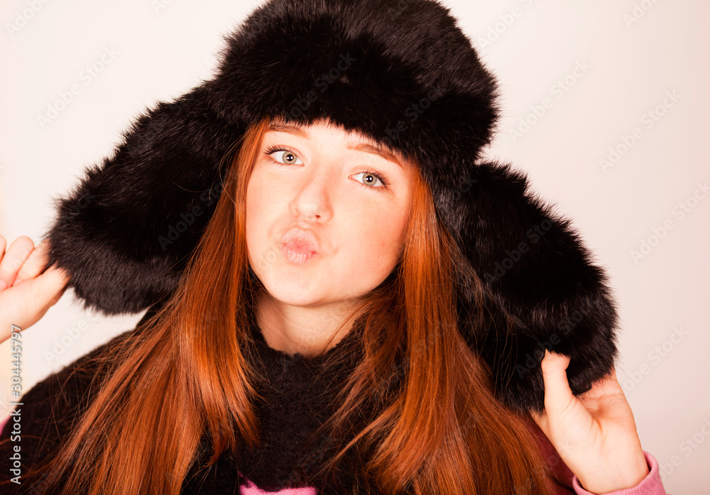 Fashion happy young woman in knitted hat and sweater having fun Fashion happy young woman in knitted hat and sweater having fun