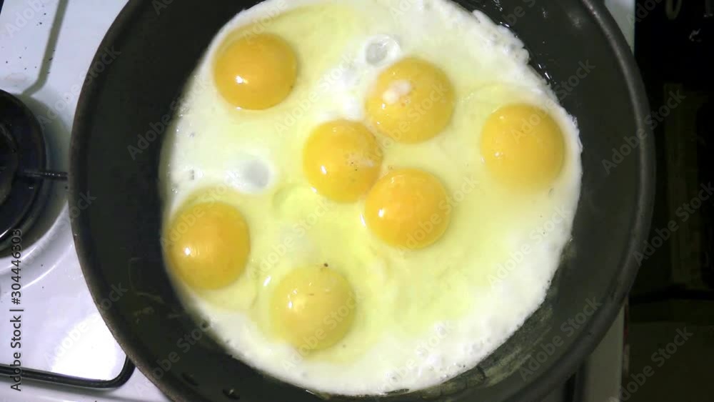 fried eggs with yellow yolks fried in a pan on a gas stove, top view fried eggs with yellow yolks fried in a pan on a gas stove, top view