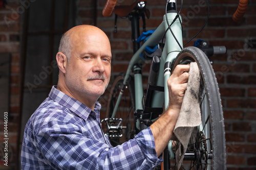 Mechanic or rider cleaning oil off a bicycle wheel